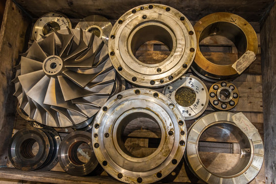 Parts of a centrifugal compressor in a wooden box, ready for repair - Powered by Adobe