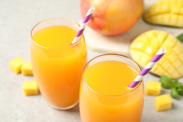 Fresh delicious mango drink on light table