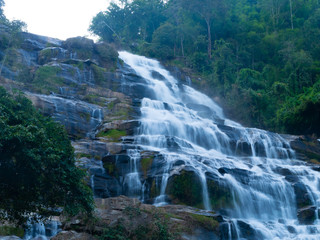 Fototapeta na wymiar Mae ya waterfall with moss and rocks located in Chiang mai, Thailand.