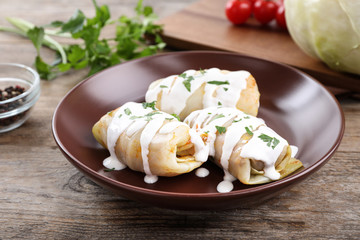 Delicious cabbage rolls served on wooden table