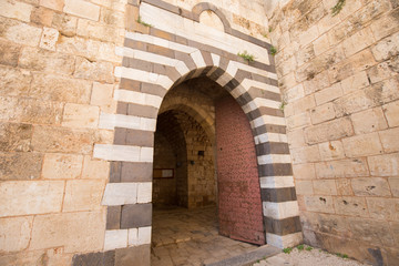 Fototapeta na wymiar The entrance to the Citadel of Raymond de Saint-Gilles, a crusader fortress. Tripoli, Lebanon - June, 2019