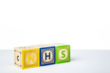 Childrens Wooden Alphabet Blocks Spelling the Word NHS