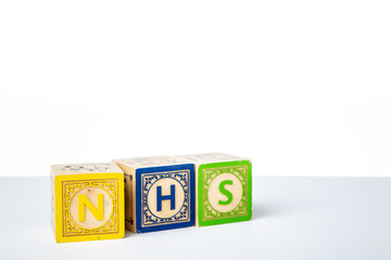 Childrens Wooden Alphabet Blocks Spelling the Word NHS