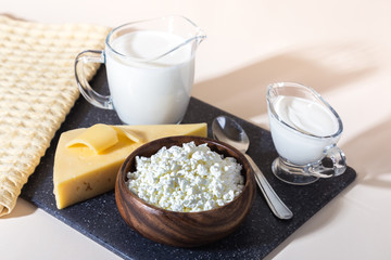 Food, source of calcium, magnesium, protein, fats, carbohydrates, balanced diet. Dairy products on the table: cottage cheese, sour cream, milk, cheese, contain casein, albumin, globulin, free lactose - obrazy, fototapety, plakaty