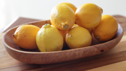 lemons in a wooden bowl