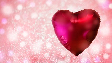 Red heart-shaped balloon on a festive pink background with sparkles and circles bokeh. The concept of love and Valentine's Day.