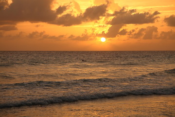 Beautiful crimson red sunset from the beach over the Caribbean Sea in Barbados, Atlantic Ocean