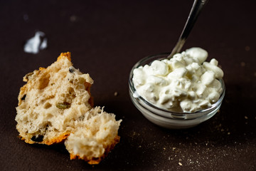 Ripped bread and cottage cheese in bowl.