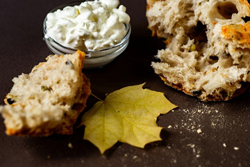 Pieces of freshly baked bread, cottage cheese and leaf.