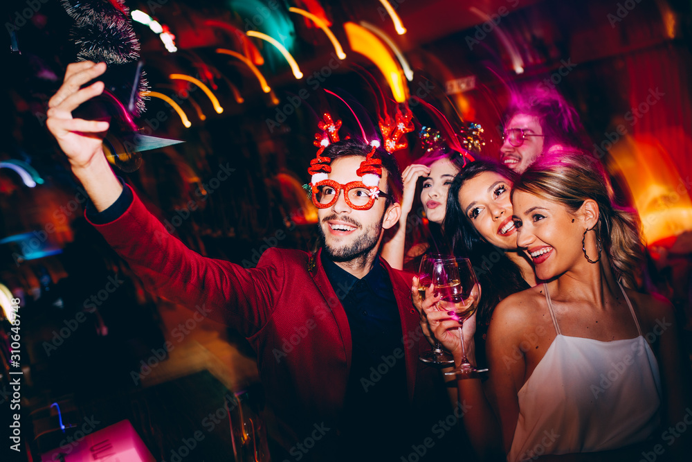 Wall mural group of young people at club making selfie and having fun