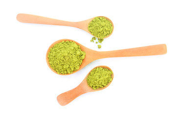 powdered matcha green tea in wood spoon, isolated on white background