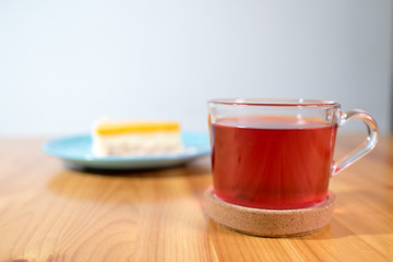Mousse dessert and fruit tea on a large bright wooden table