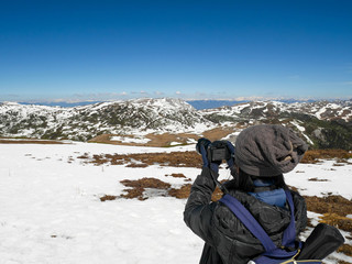 Fototapeta na wymiar Traveler taking photos of Shika Snow Mountain