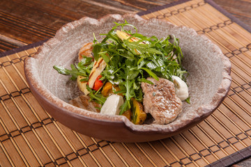 Salad with arugula and roast pork