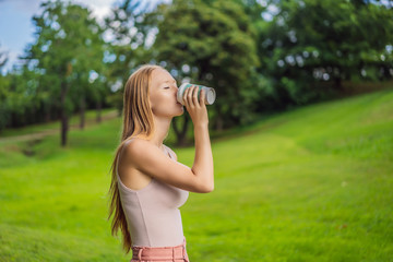 Obraz premium Dreamy young woman having a cup of coffee outside