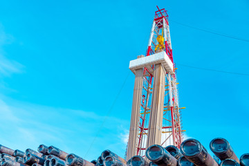Oil and Gas Drilling Rig onshore dessert with dramatic cloudscape. Oil drilling rig operation on...