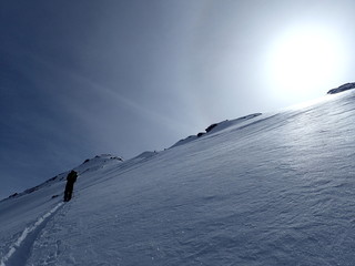 Ski touring, snowboarding and splitboarding in a Beautiful snowy winter mountain landscape in the Swiss alps