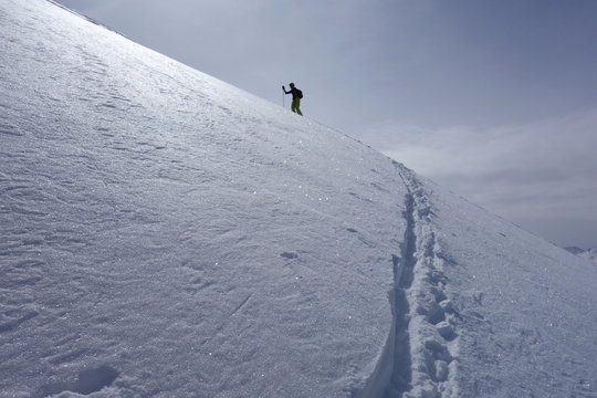 Ski touring, snowboarding and splitboarding in a Beautiful snowy winter mountain landscape in the Swiss alps