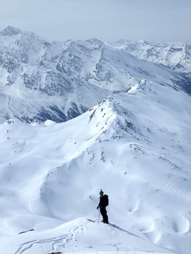 Ski touring, snowboarding and splitboarding in a Beautiful snowy winter mountain landscape in the Swiss alps
