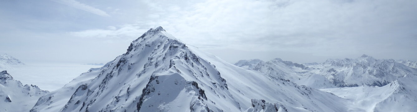 Ski touring, snowboarding and splitboarding in a Beautiful snowy winter mountain landscape in the Swiss alps