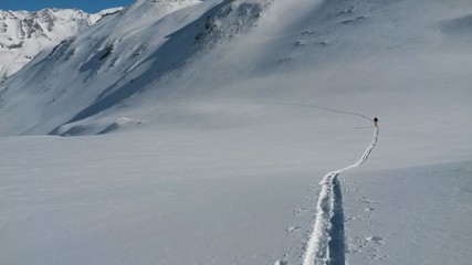 Ski touring, snowboarding and splitboarding in a Beautiful snowy winter mountain landscape in the Swiss alps