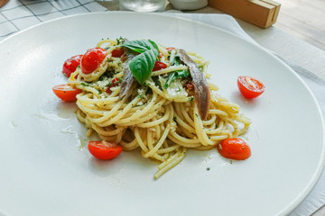 Salted fish spaghetti served in a white dish