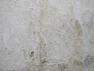 The wall damage and peeling paint because of water leaks, White cement wall with mold texture background.