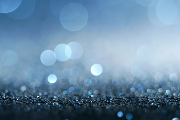 blue Sparkling Lights Festive background with texture. Abstract Christmas twinkled bright bokeh defocused and Falling stars. Winter Card or invitation	