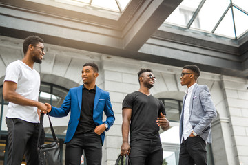 Obraz premium four handsome young african men on the background of the building
