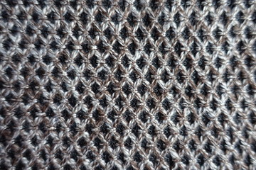 Greyish brown woolen fabric with diamond pattern from above