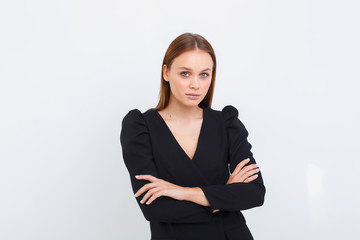 young business woman crossed her arms against a light background. elegance girl on white background