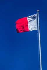 Fototapeta na wymiar Flag of Malta on flagpole.