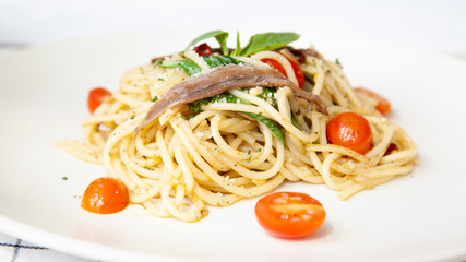 Spaghetti with anchovy, cherry tomato, onion, chili and pamersan cheese