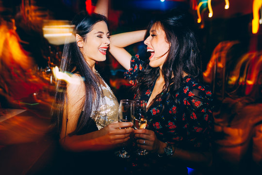 Two girls having fun at the club on New Year's party