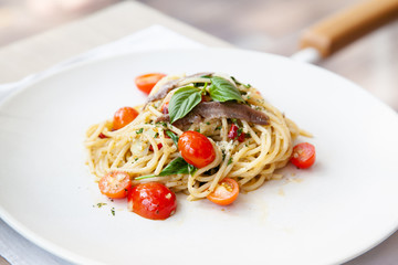 Spaghetti with anchovy, cherry tomato, onion, chili and pamersan cheese