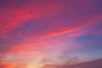 Background created from sky at sunset covered with red clouds.