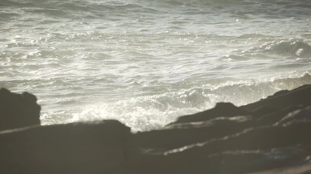 Waves crashing on rocks.