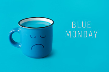 blue mug with sad face and text blue monday.