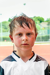 boy exhausted from playing football