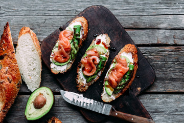 Sandwich with cream cheese, avocado, asparagus and salted salmon