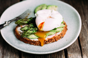 Sandwich with cream cheese, avocado, asparagus and poached egg