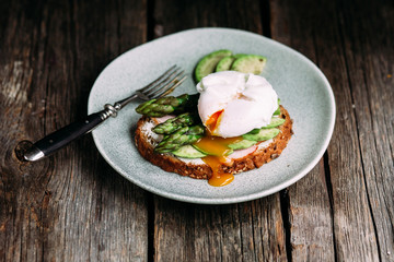 Sandwich with cream cheese, avocado, asparagus and poached egg