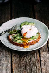 Sandwich with cream cheese, avocado, asparagus and poached egg