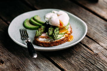 Sandwich with cream cheese, avocado, asparagus and poached egg