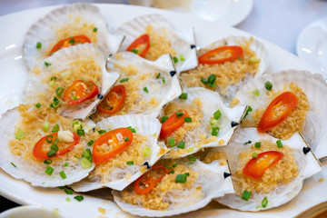 Grilled scallops with butter and vegetable in shell