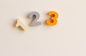 set of wooden colorful rooms. Toy children's figures on a white background. The concept of teaching children numbers and parenting. Bright colored, wooden numbers. the view from the top. 