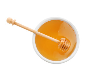 Bowl of organic honey and dipper isolated on white, top view