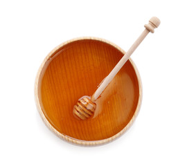 Bowl of organic honey and dipper isolated on white, top view