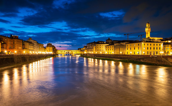 Panoramic night view of famous Ponte Vecchio over Arno River in Florence, Italy.