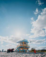 Wide angle vertical photo of yellow lifeguard tower in Miami Beach, Florida, USA
